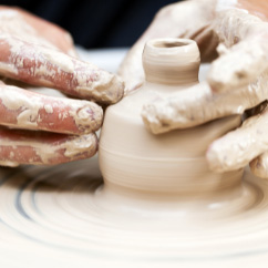 Hand building and refining pottery at the table